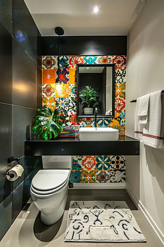 Contemporary powder room with colorful patterned tiles black vanity and tropical plants