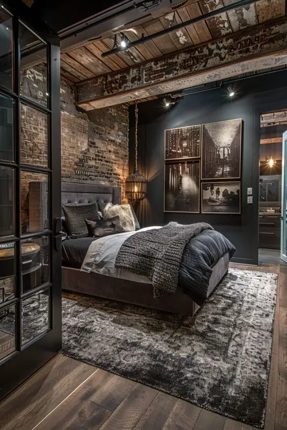 Industrial bedroom with exposed brick dark walls and vintage photographs