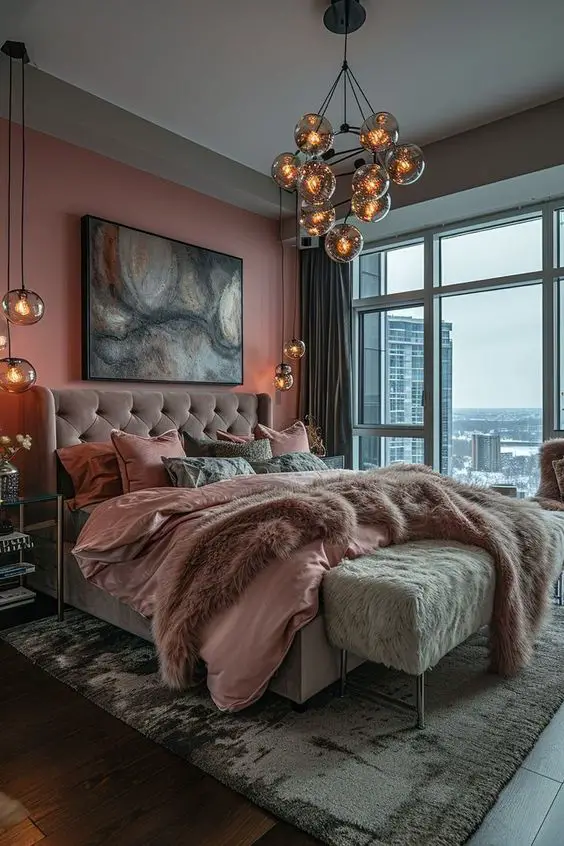 Modern highrise bedroom with pink walls glass pendant lights and city views