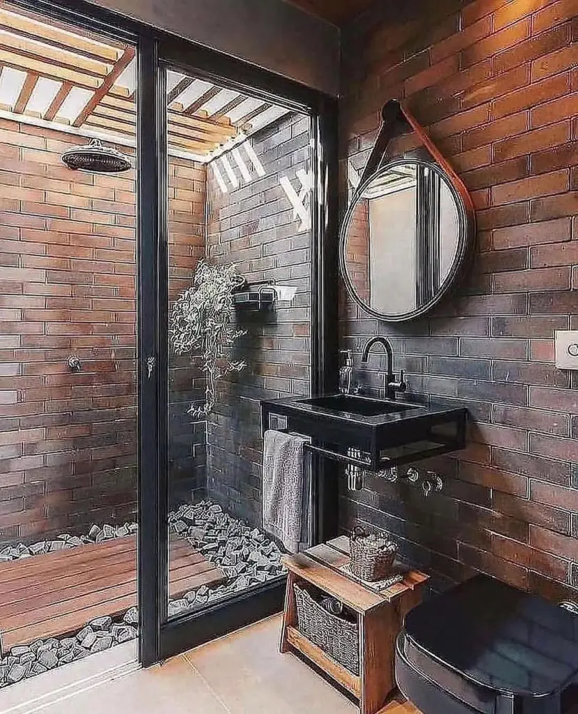 Industrial bathroom with brick walls black sink and wooden elements