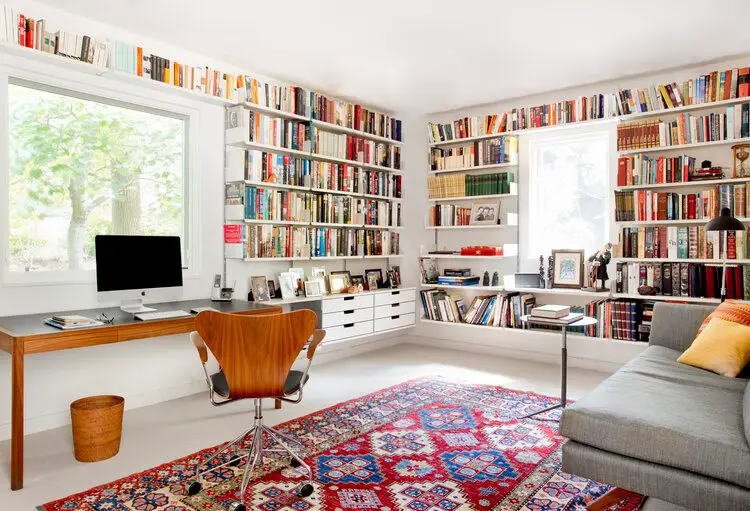 Home office with built in bookshelves and vintage style rug