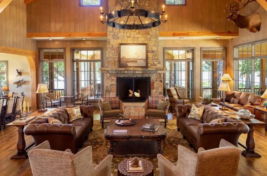 Grand living room with exposed beams antler chandeliers and leather furniture