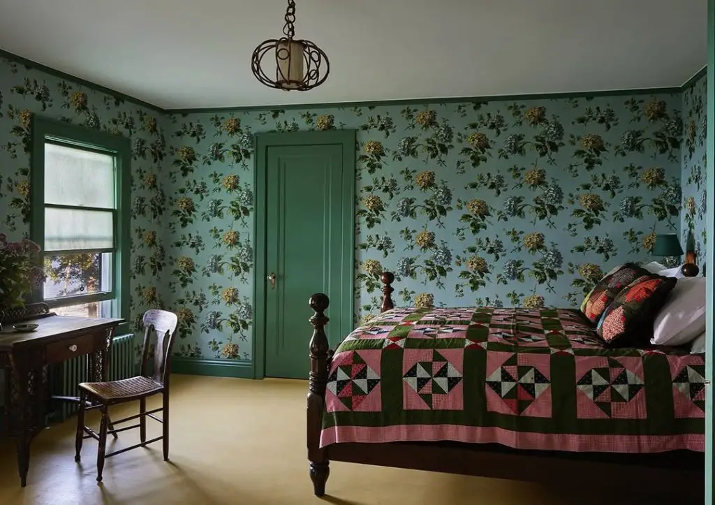 Traditional bedroom with floral wallpaper antique bed and vintage quilt