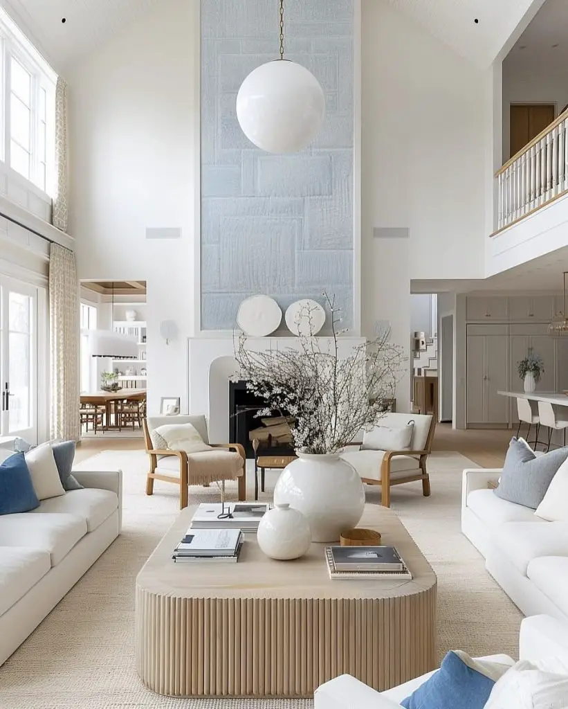 Living room with vaulted ceiling stone fireplace and velvet accent chairs