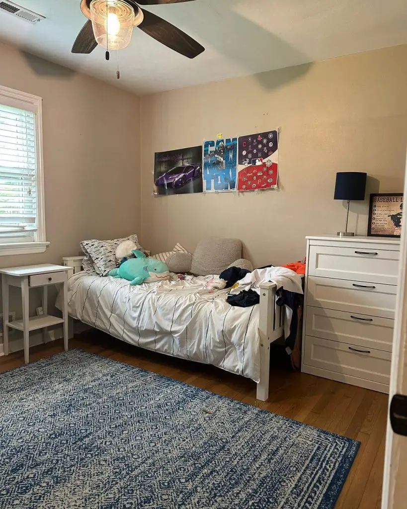 White loft bed with desk space and rattan chair underneath