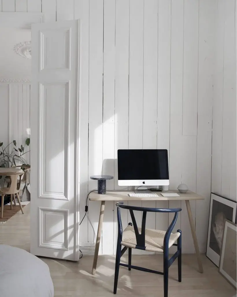 Modern office with backlit shelving and geometric floor pattern