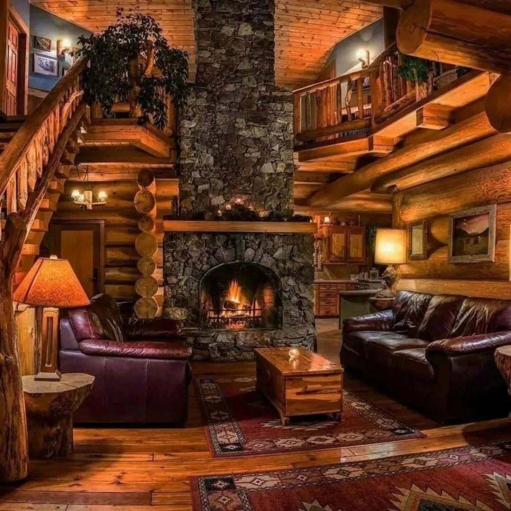 Rustic living room with stone fireplace and leather armchairs