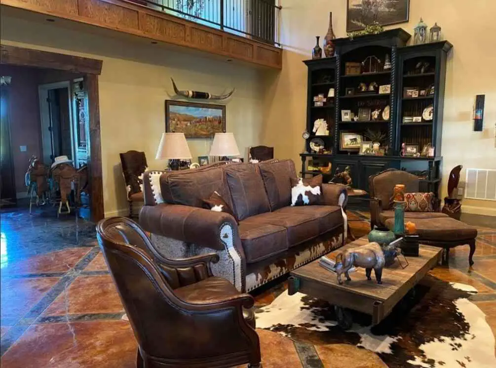 Rustic cabin room with wood walls stone fireplace and vintage decor