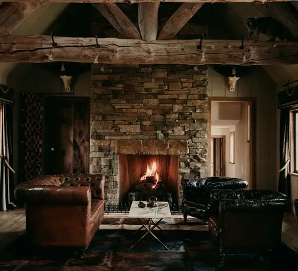 Dark study room with fireplace and built in bookshelves