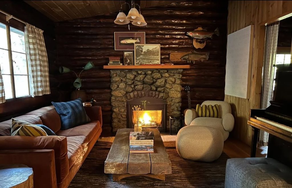 Contemporary living room with blue velvet sofa stone fireplace and geometric decor