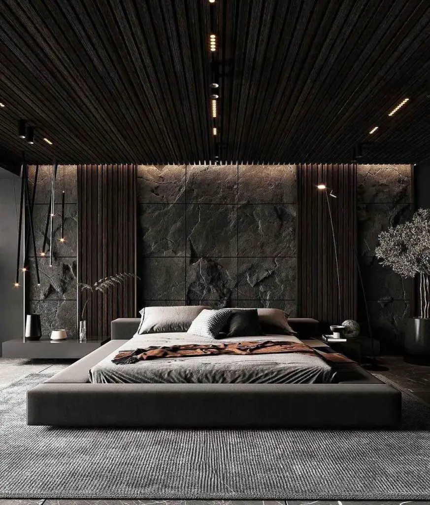 Modern dark bedroom with ambient lighting and stone wall
