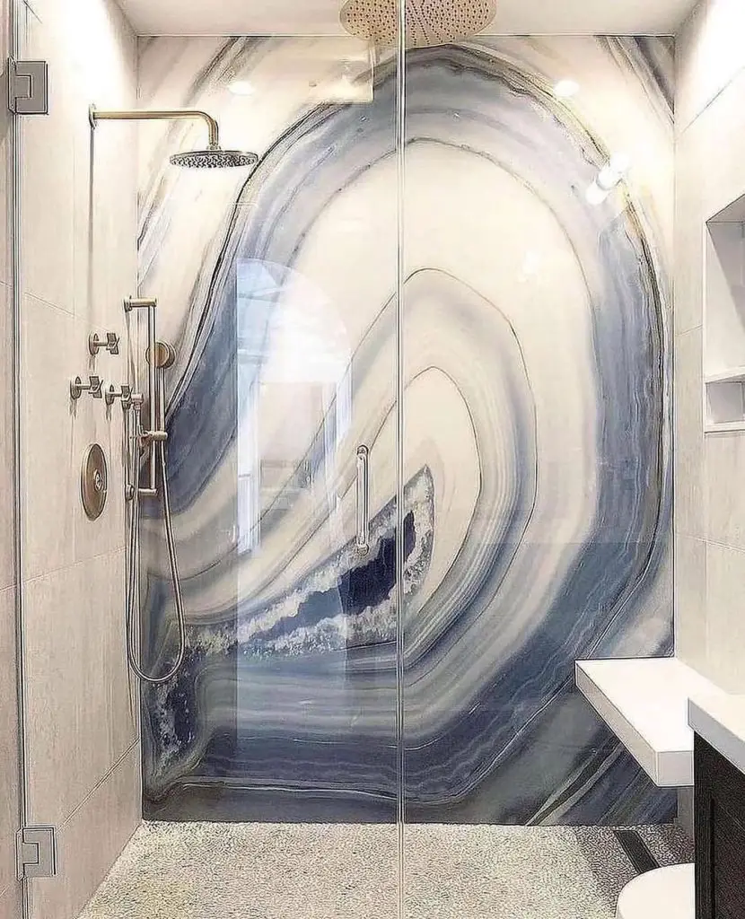 Shower with large wave pattern wall art and gold fixtures