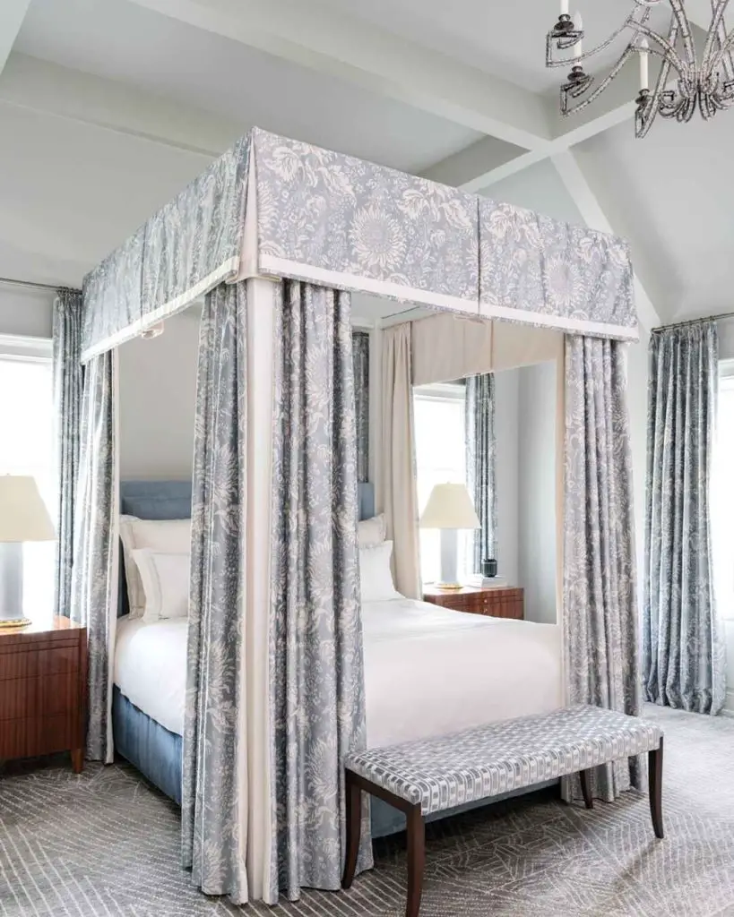 Bedroom with gray canopy bed and matching curtains