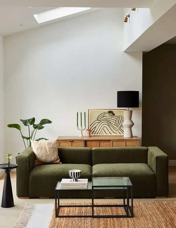 White living room with grey sofas line art and floating shelves