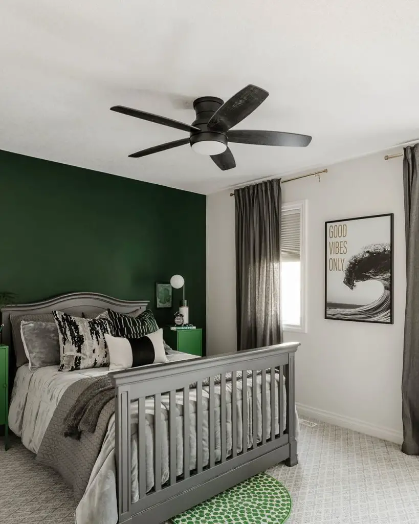 Modern bedroom with sage green accent wall and geometric bedding patterns