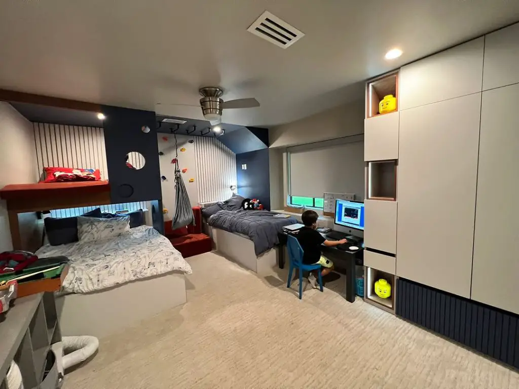 Teen bedroom with gaming setup climbing wall and built in storage