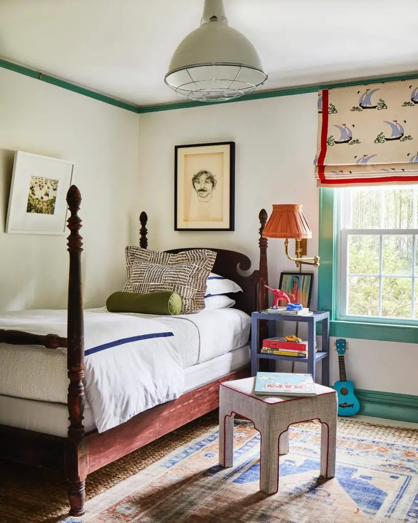 Boys bedroom with portrait art wooden bed and patterned shades