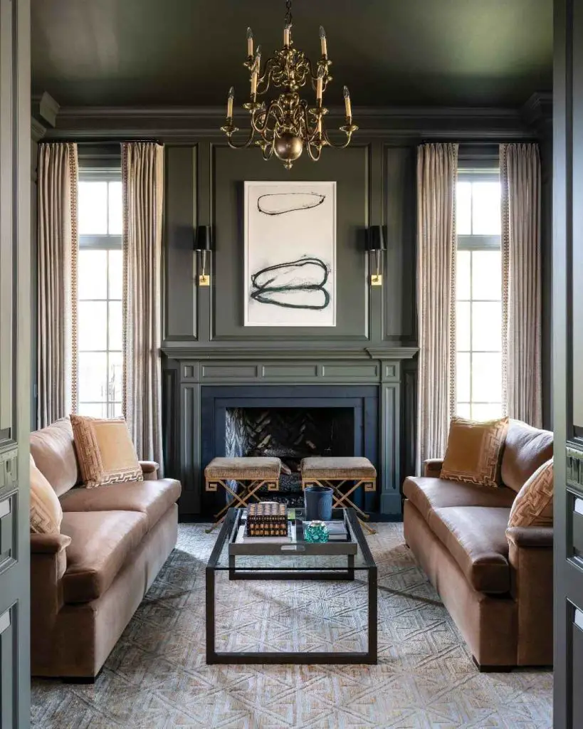 Green living room with brass chandelier and velvet sofas