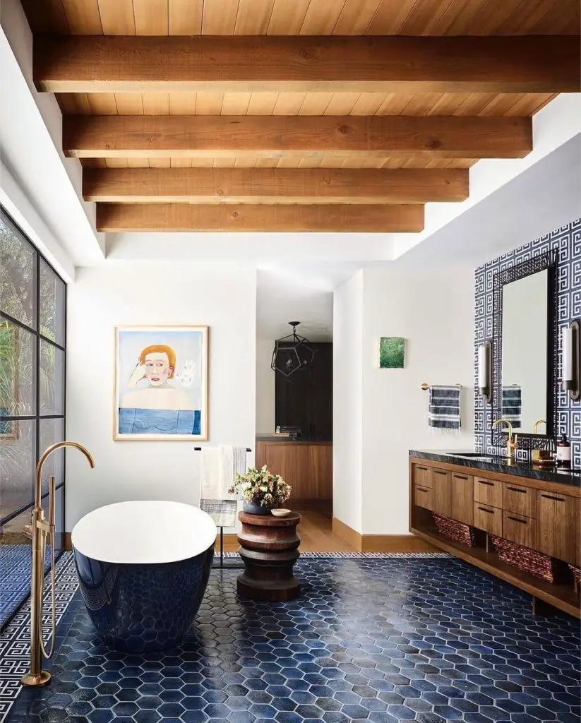 Bathroom with wooden ceiling beams navy tiles and modern tub