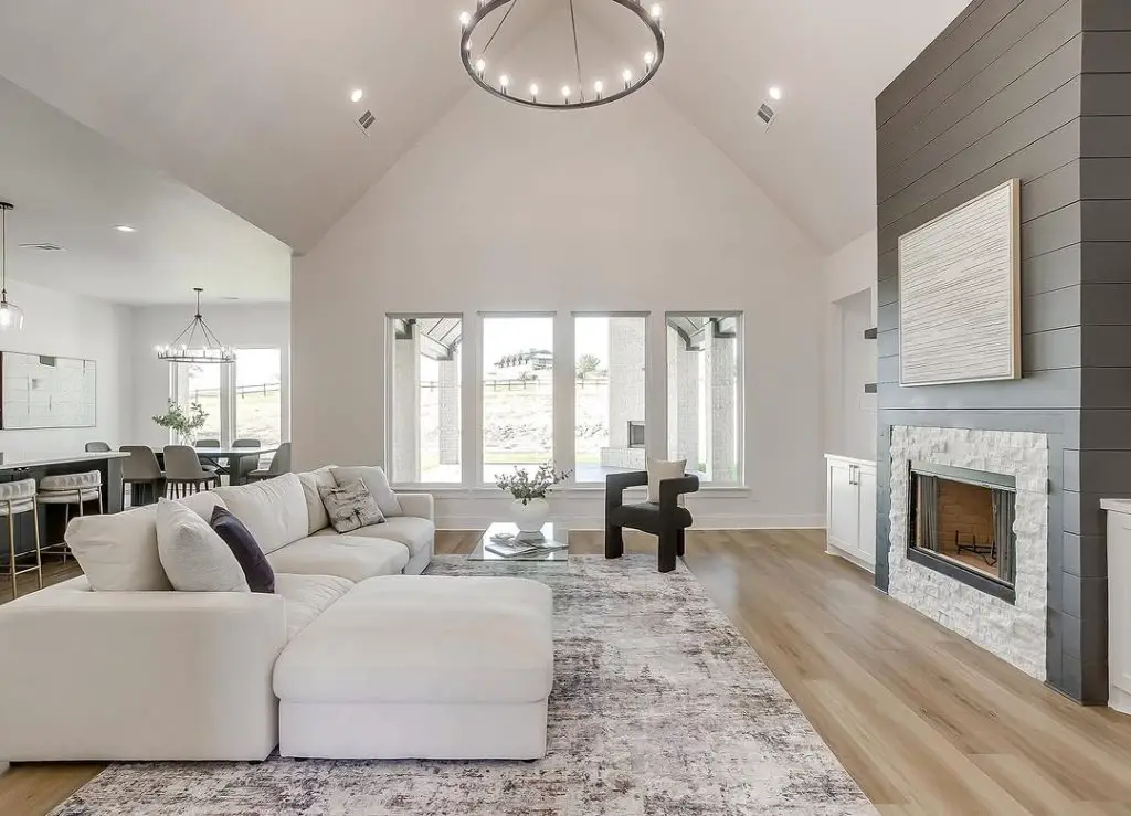 Contemporary ranch living room with white sectional stone fireplace and modern lighting