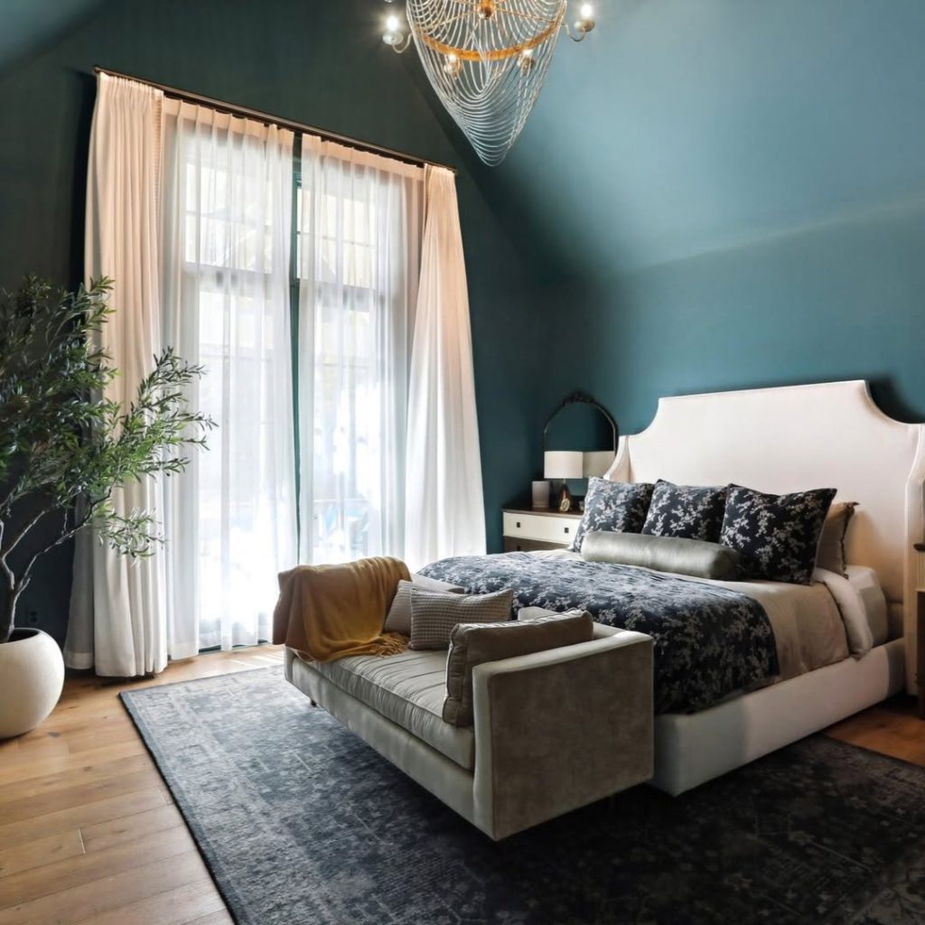 Dark green paneled bedroom with brass accents and velvet furnishings