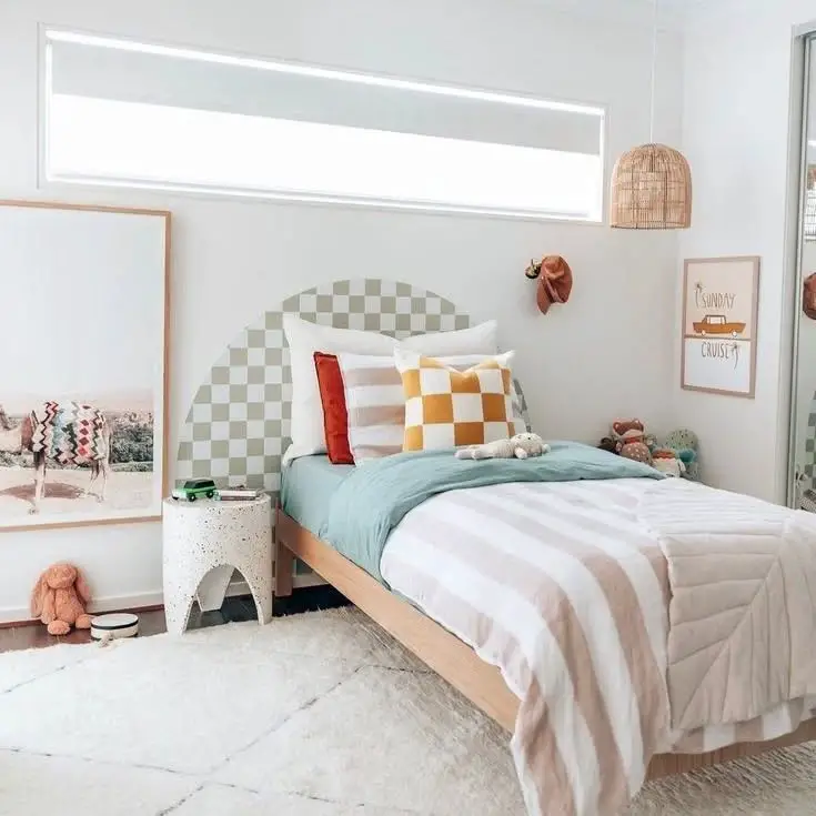 Kids bedroom with checkered headboard pastel accents and vintage inspired decor