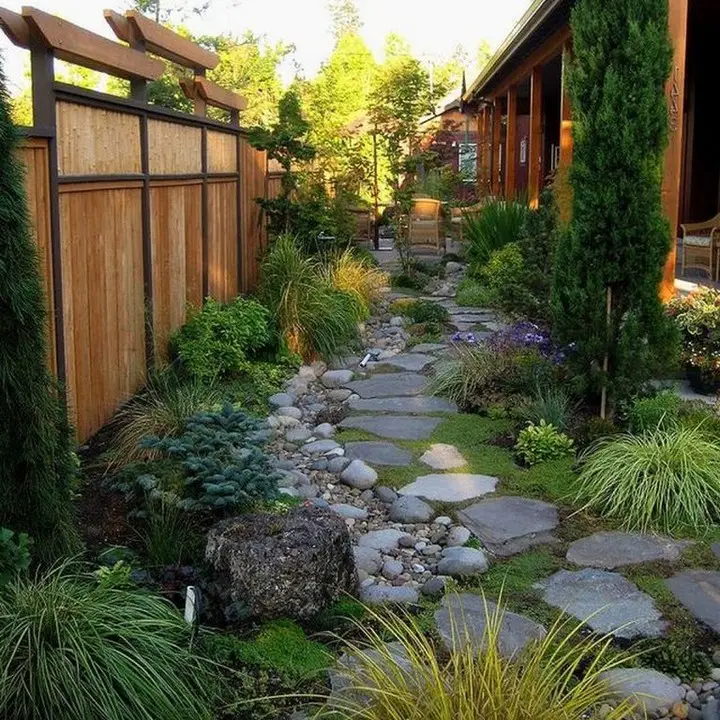 Stepping stone path between curved raised wooden garden beds