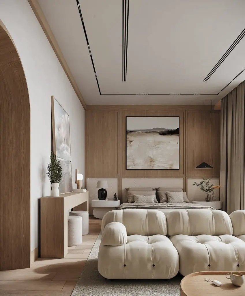 Modern bedroom with wooden walls plush white seating and abstract artwork