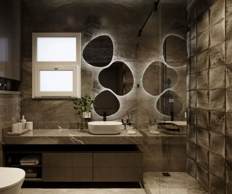 Modern bathroom with circular mirrors and stone accent wall