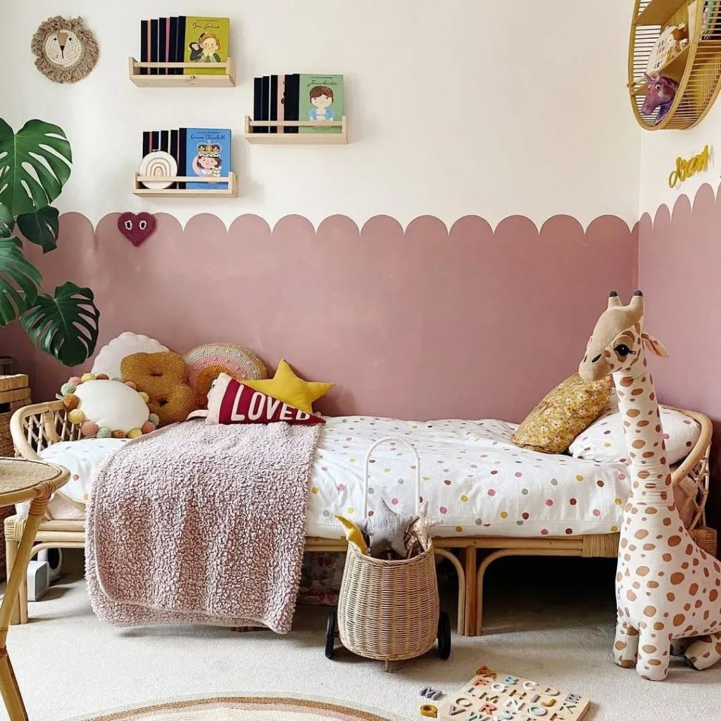 Kids reading nook with floating shelves pink walls and safari themed decor