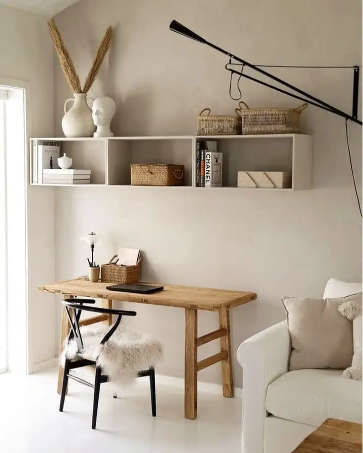 Traditional home office with sage walls built in shelving and window seats