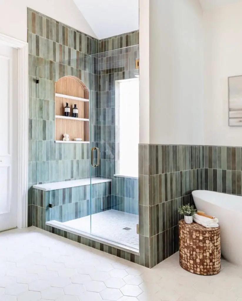 Modern shower with green vertical tiles and arched storage niche