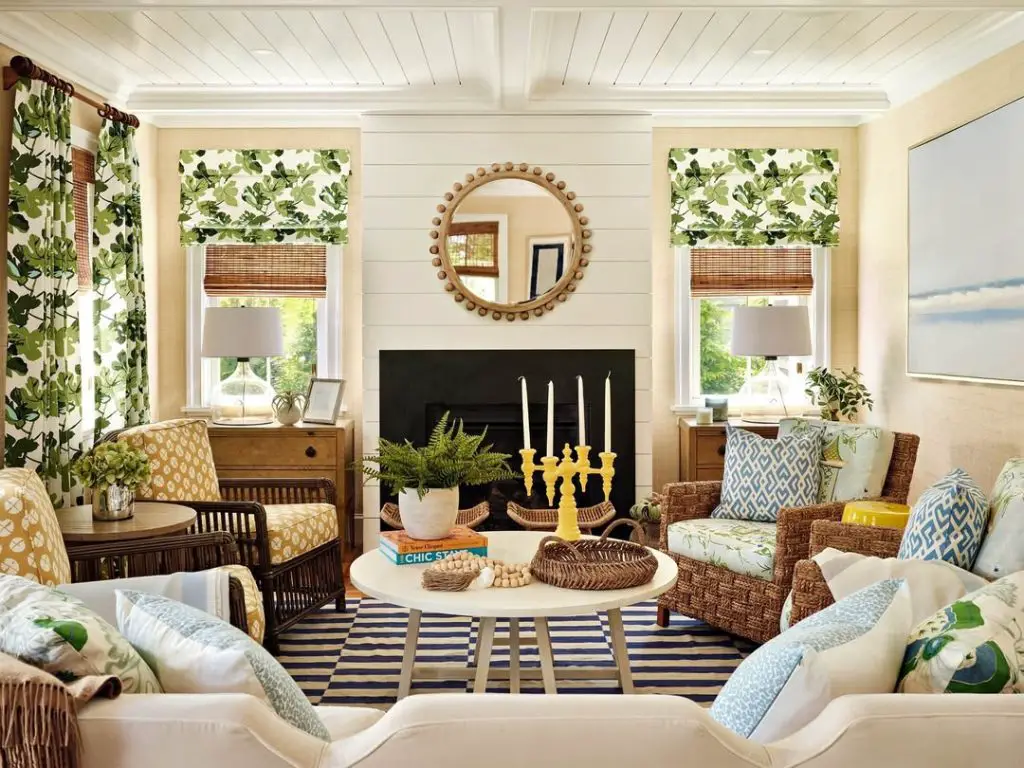 Coastal living room with shiplap fireplace floral curtains and woven furniture