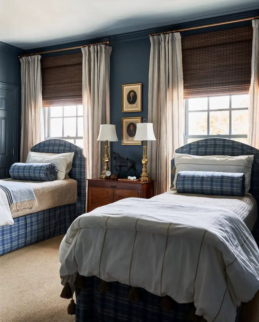 Twin bedroom with navy walls plaid beds and classic decor