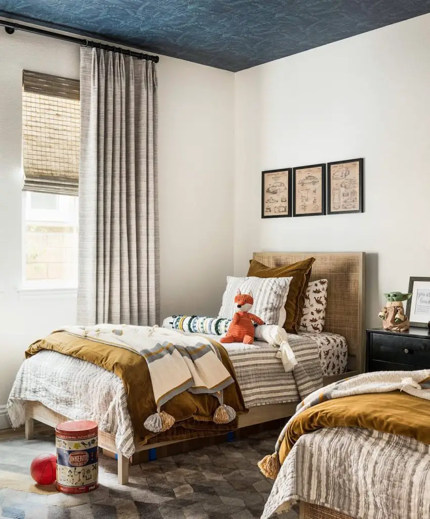 Boys bedroom with neutral colors vintage prints and textured bedding