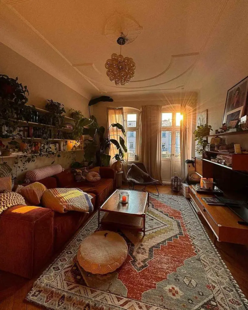 Living room with sectional sofa vintage rug and large windows.