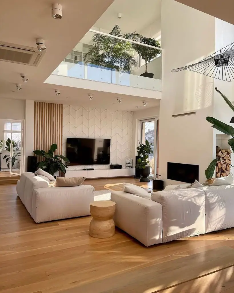 Modern living room with double height ceiling indoor plants and white sectional