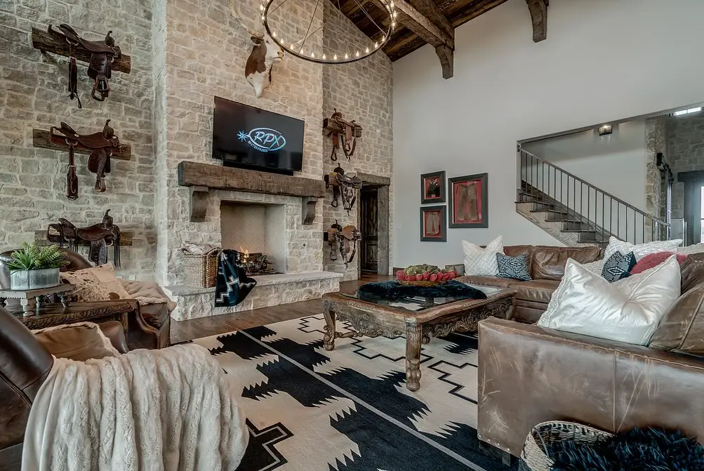 Contemporary mountain living room with vaulted ceiling modern lighting and stone fireplace