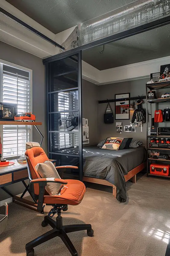 Industrial style bedroom with orange office chair and glass partition