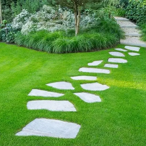 Rectangular concrete pavers arranged geometrically in green lawn