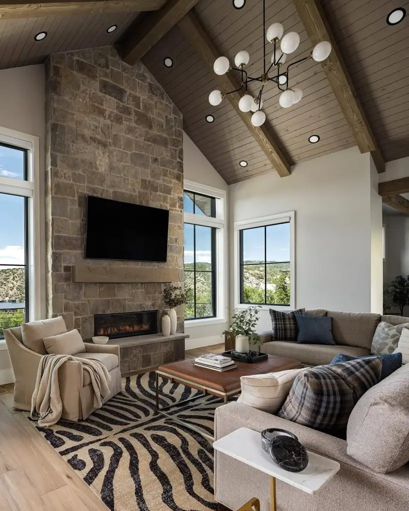 Modern ranch style room with reclaimed wood wall leather furniture and windmill fan