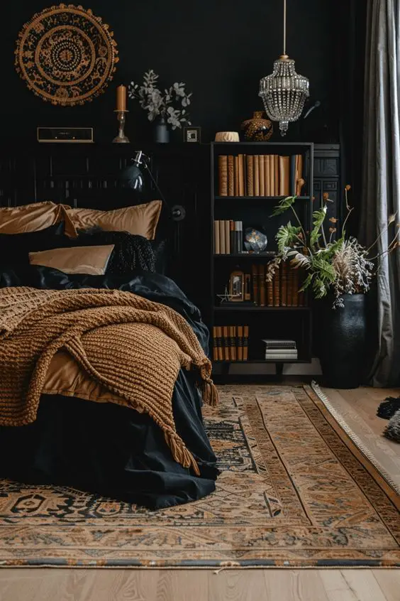 Dark bedroom with amber bedding crystal chandelier and vintage wall art