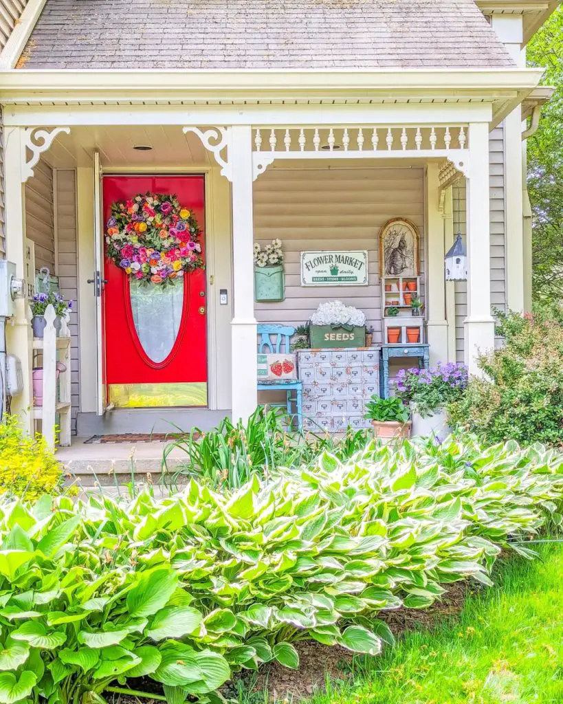 Victorian porch with red door vintage seed drawers and floral display