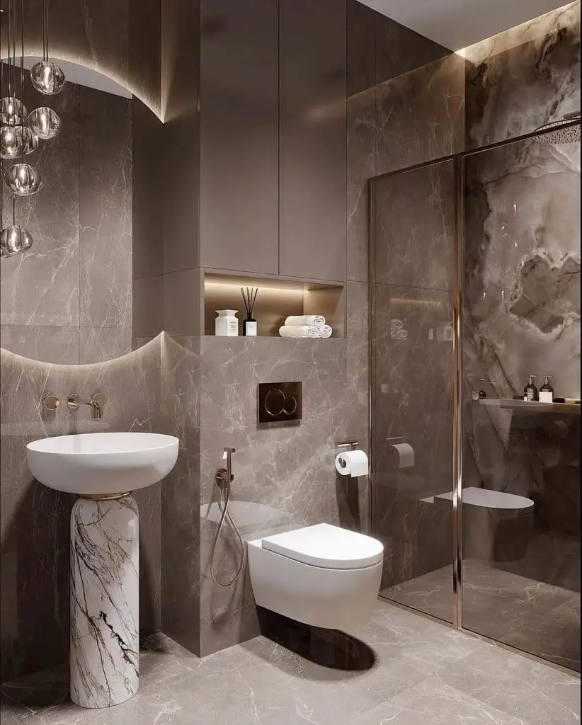 Contemporary bathroom with dark marble walls white fixtures and pendant lighting