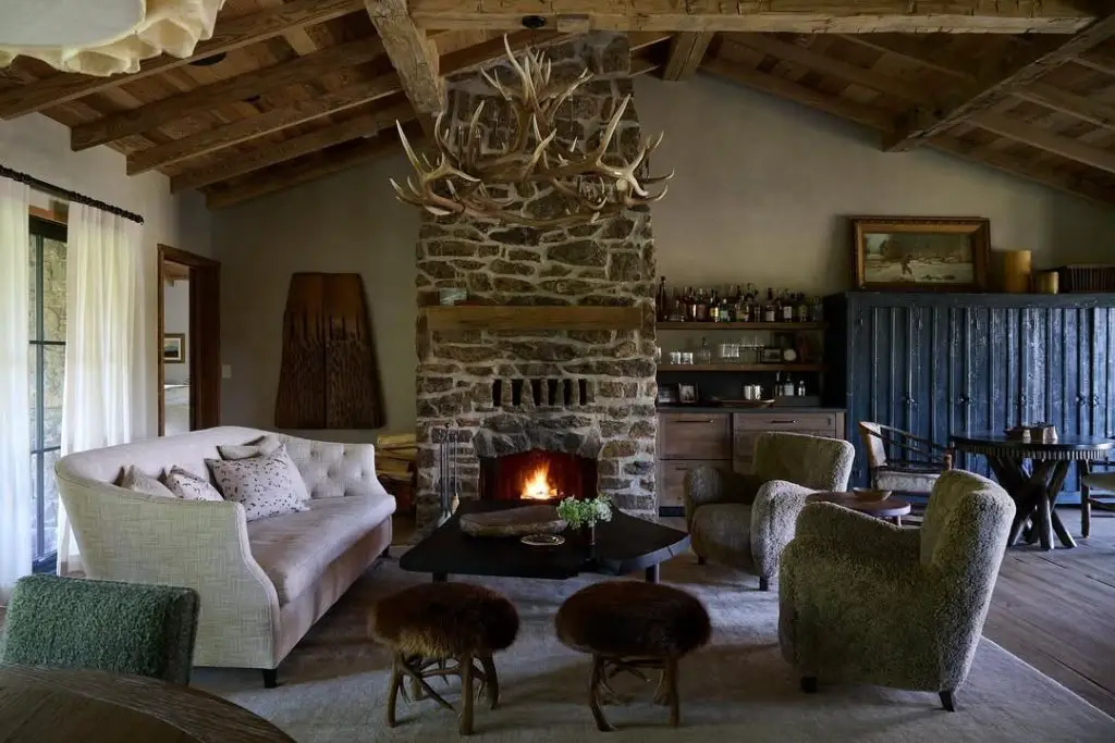 Modern ranch media room with stone fireplace leather chairs and floating shelves