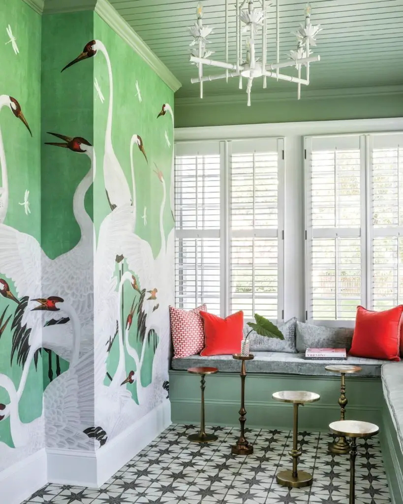 Green room with white crane wallpaper and window seat cushions