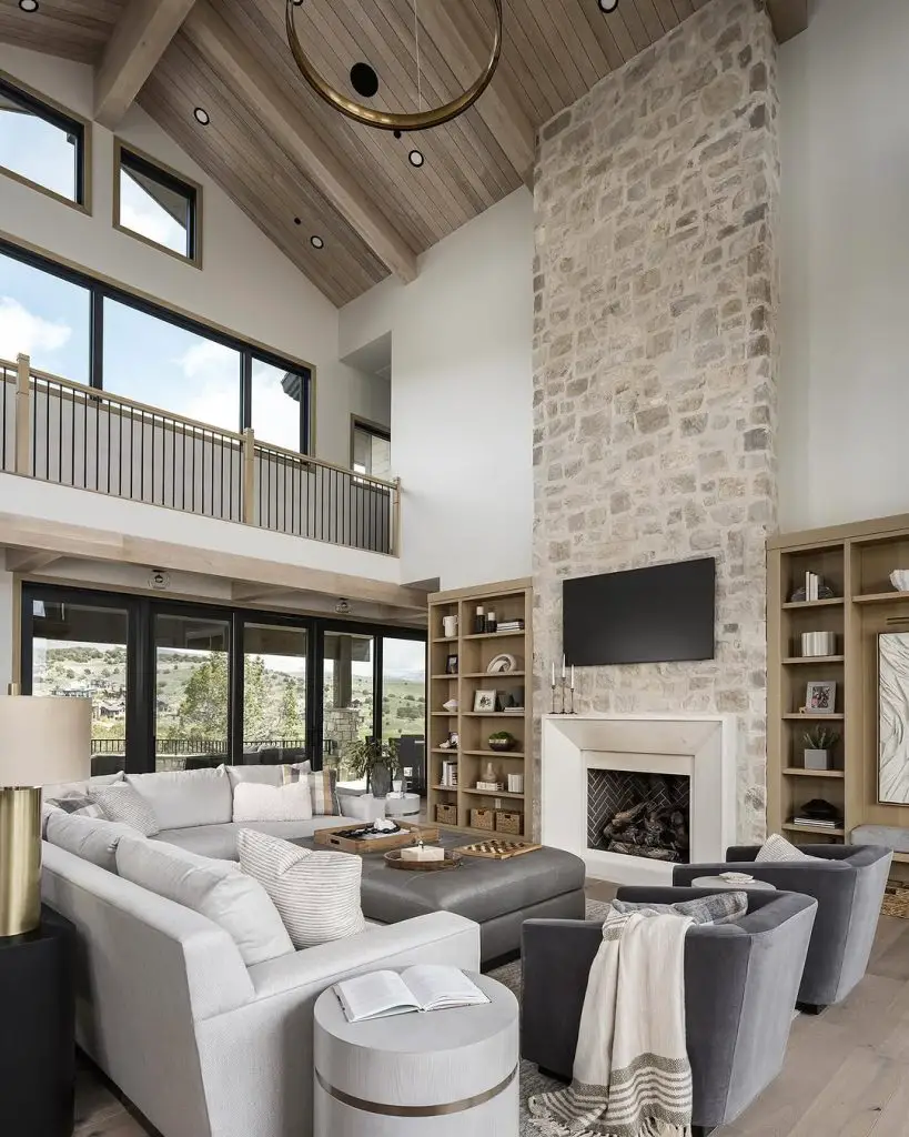 Contemporary great room with vaulted ceiling stone fireplace and neutral sectional