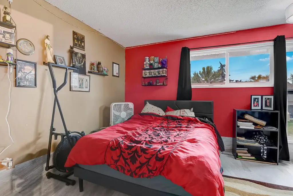 Gaming bedroom setup with blue built-in storage bed desk and shelving
