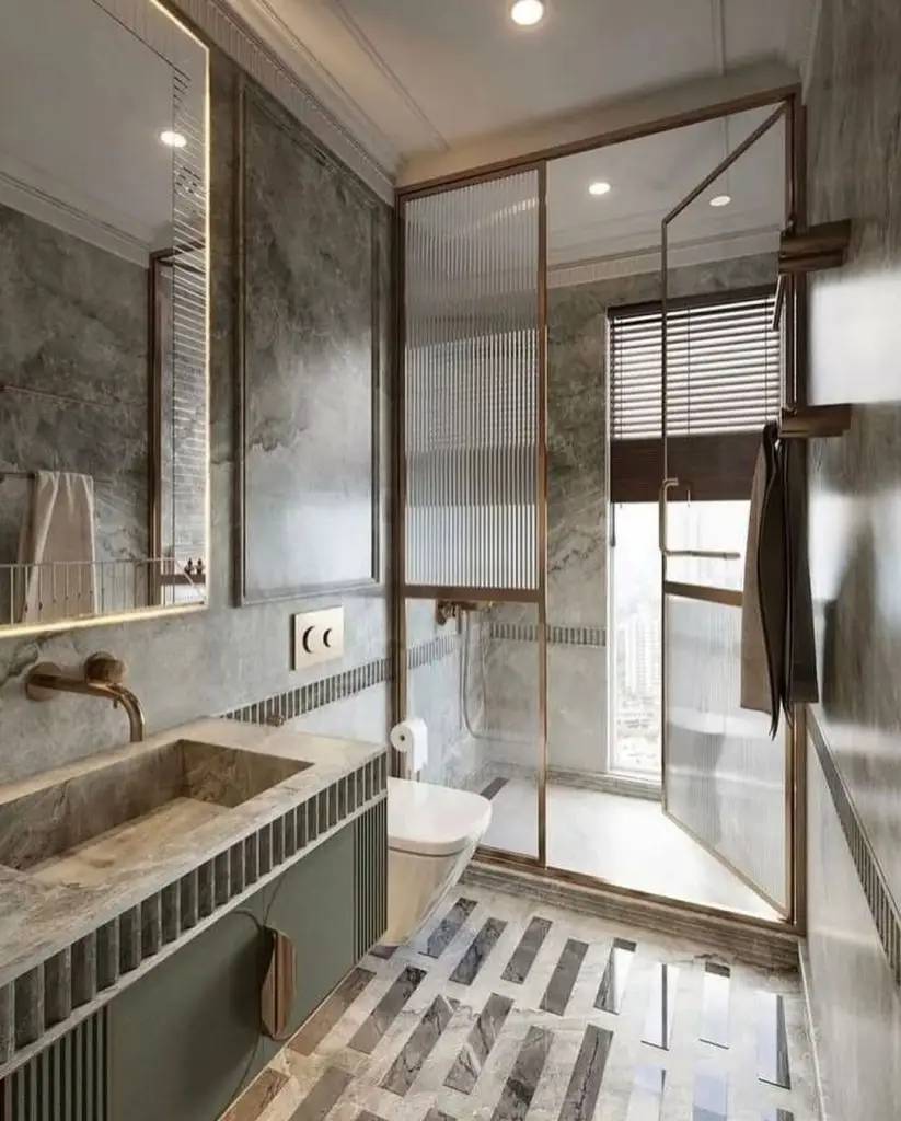 Modern bathroom with geometric floor pattern bronze frames and textured walls