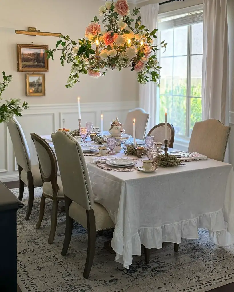 Elegant dining room with suspended floral arrangement and formal place settings